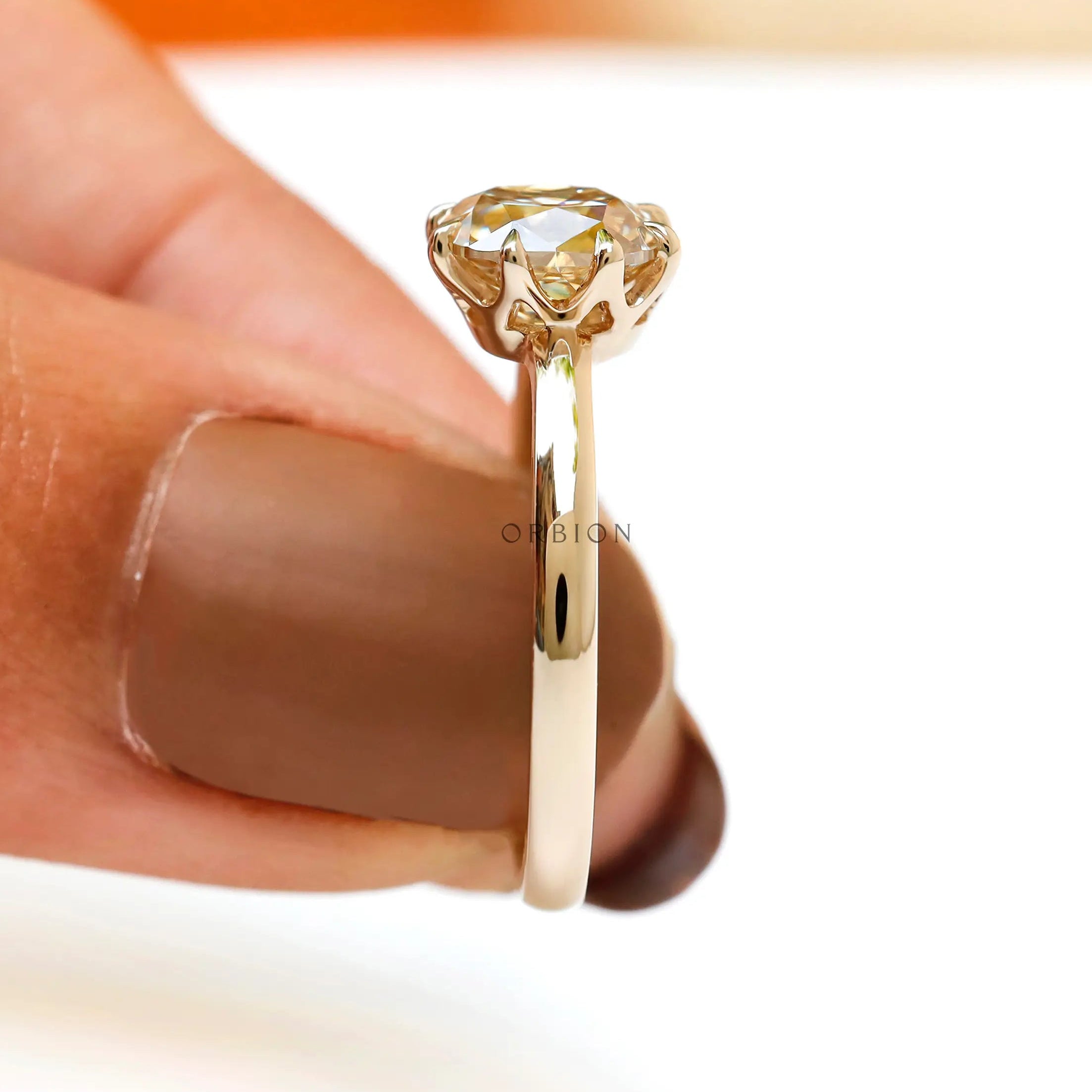 Champagne Moissanite solitaire ring viewed from side with a focus on setting