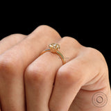 Hand wearing Champagne Moissanite solitaire engagement ring with neutral