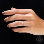 Champagne Moissanite solitaire ring on hand against dark background, elegant fit