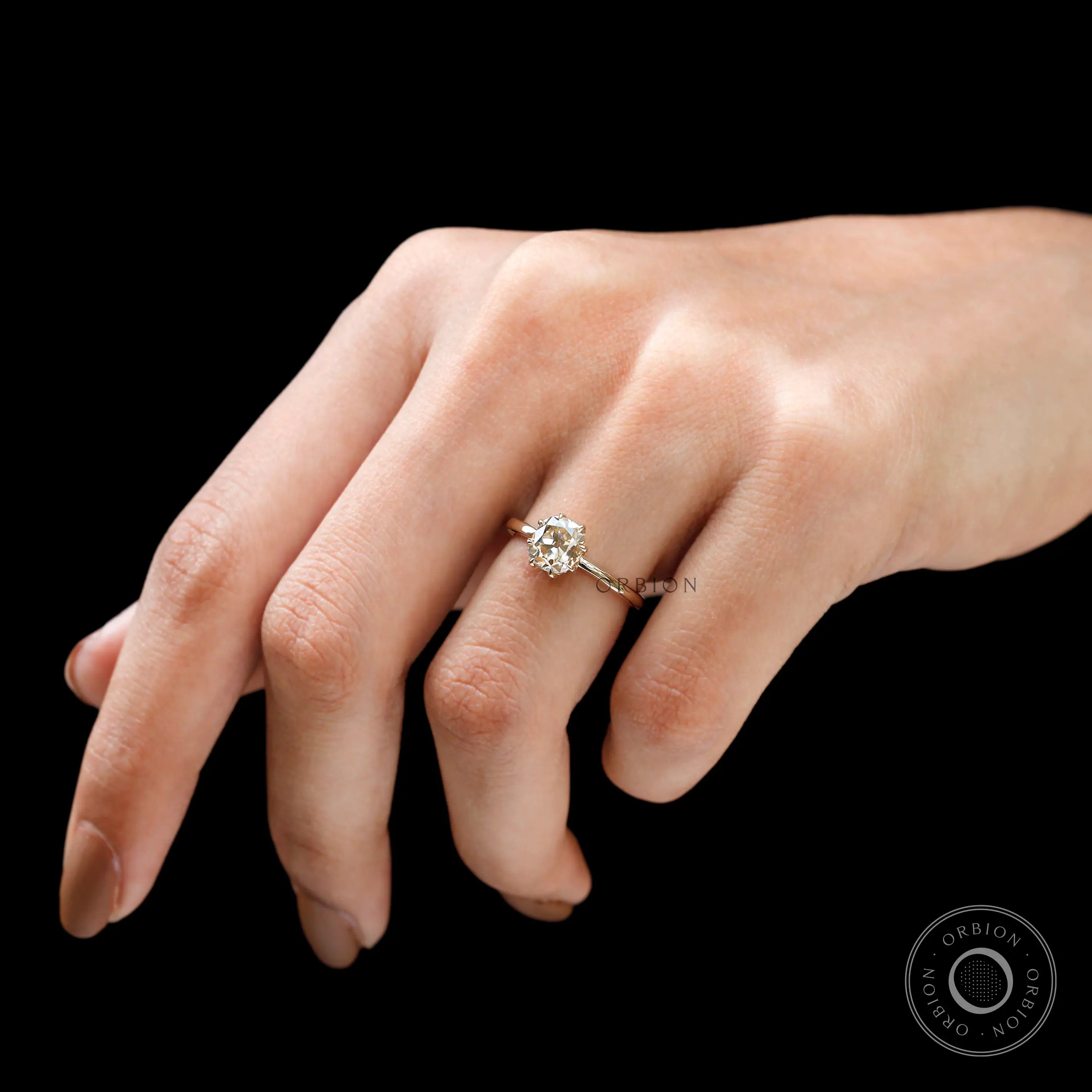 Side rare view of solitaire engagement ring worn on hand