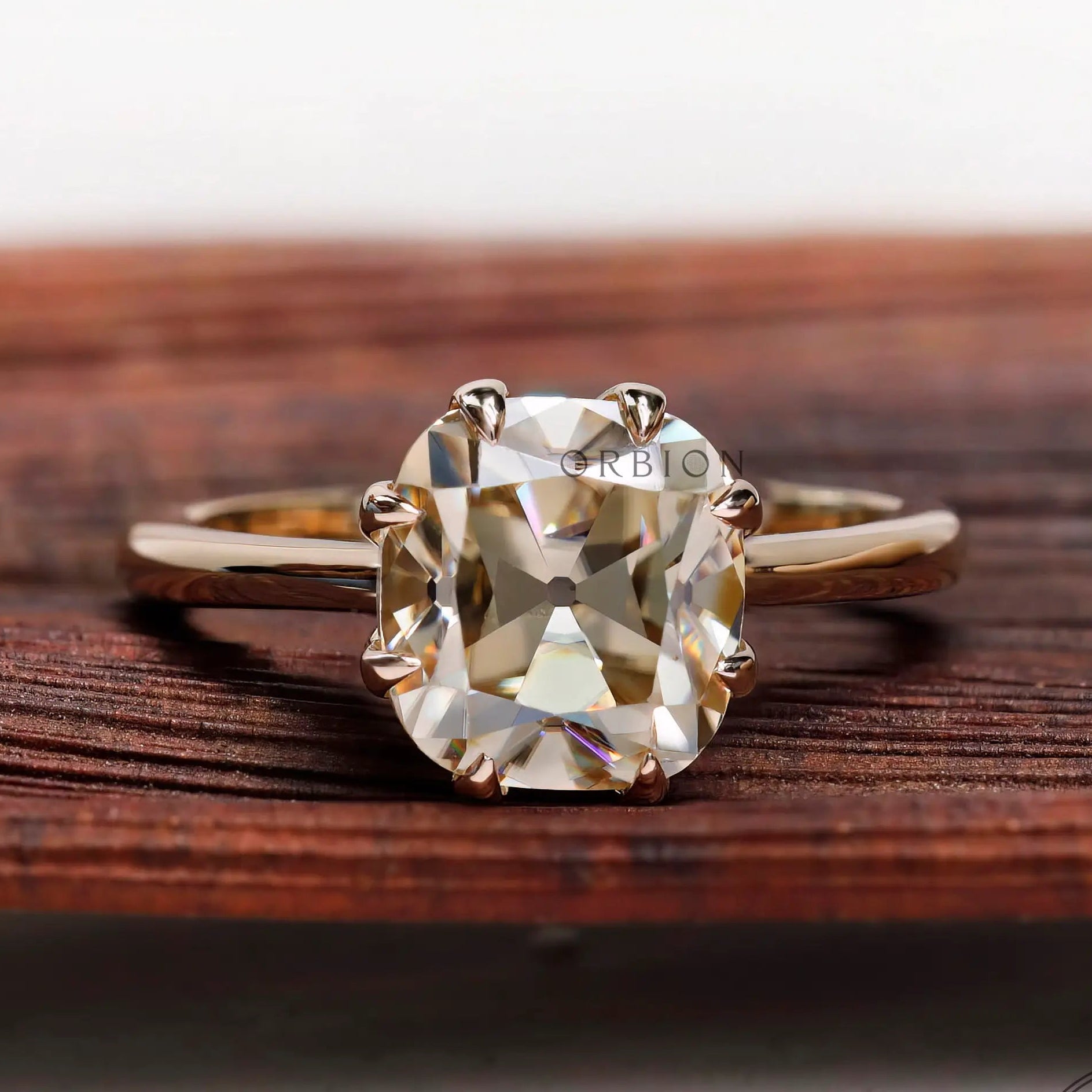 Cushion Old Mine Cut light champagne moissanite solitaire ring in yellow gold front view