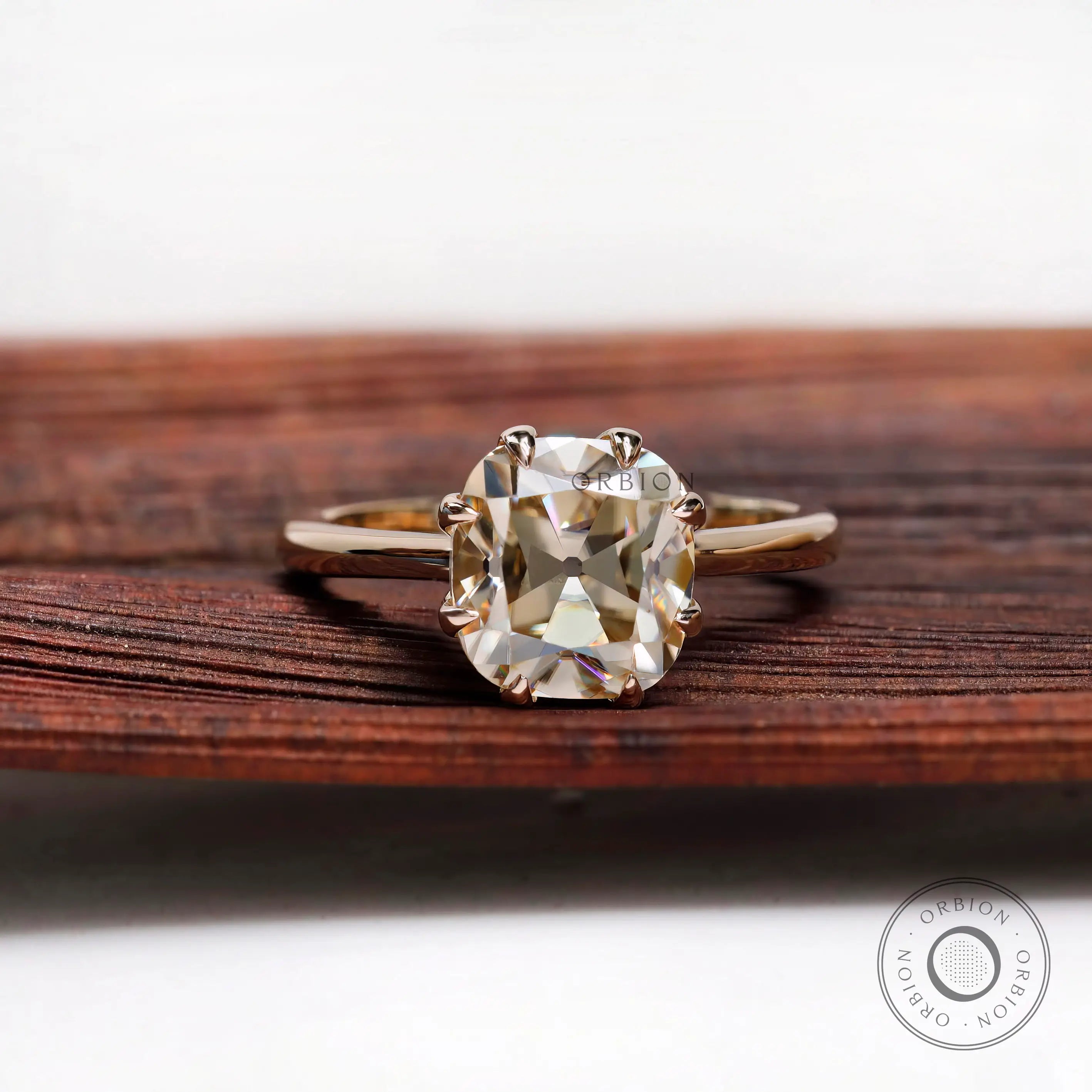 Cushion Old Mine Cut light champagne moissanite solitaire ring in yellow gold front view