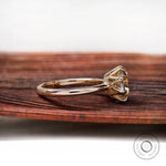 Side profile of cushion Old Mine Cut moissanite solitaire ring in 10K yellow gold