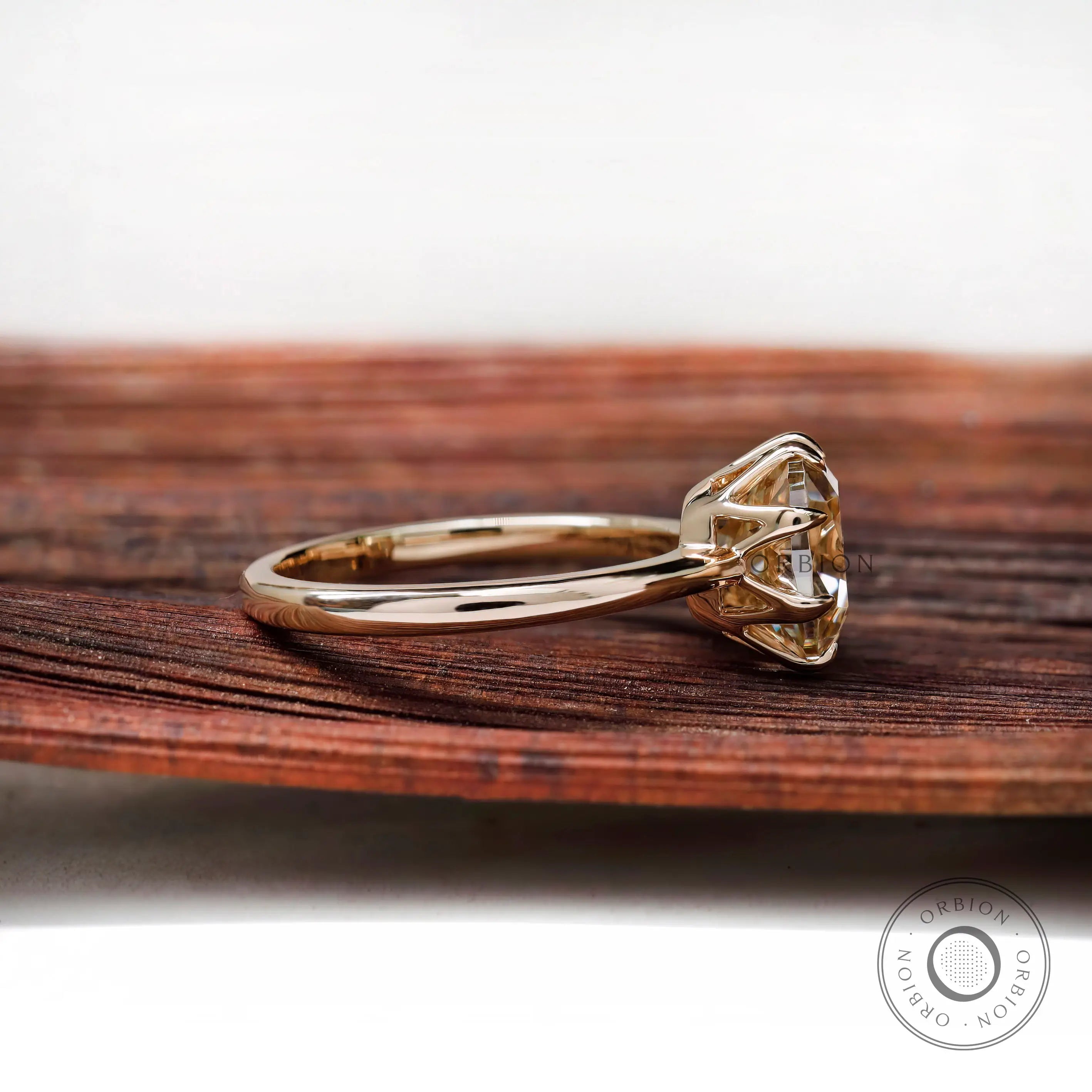 Side profile of cushion Old Mine Cut moissanite solitaire ring in 10K yellow gold