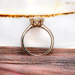 Rear view of cushion moissanite solitaire ring with polished yellow gold band
