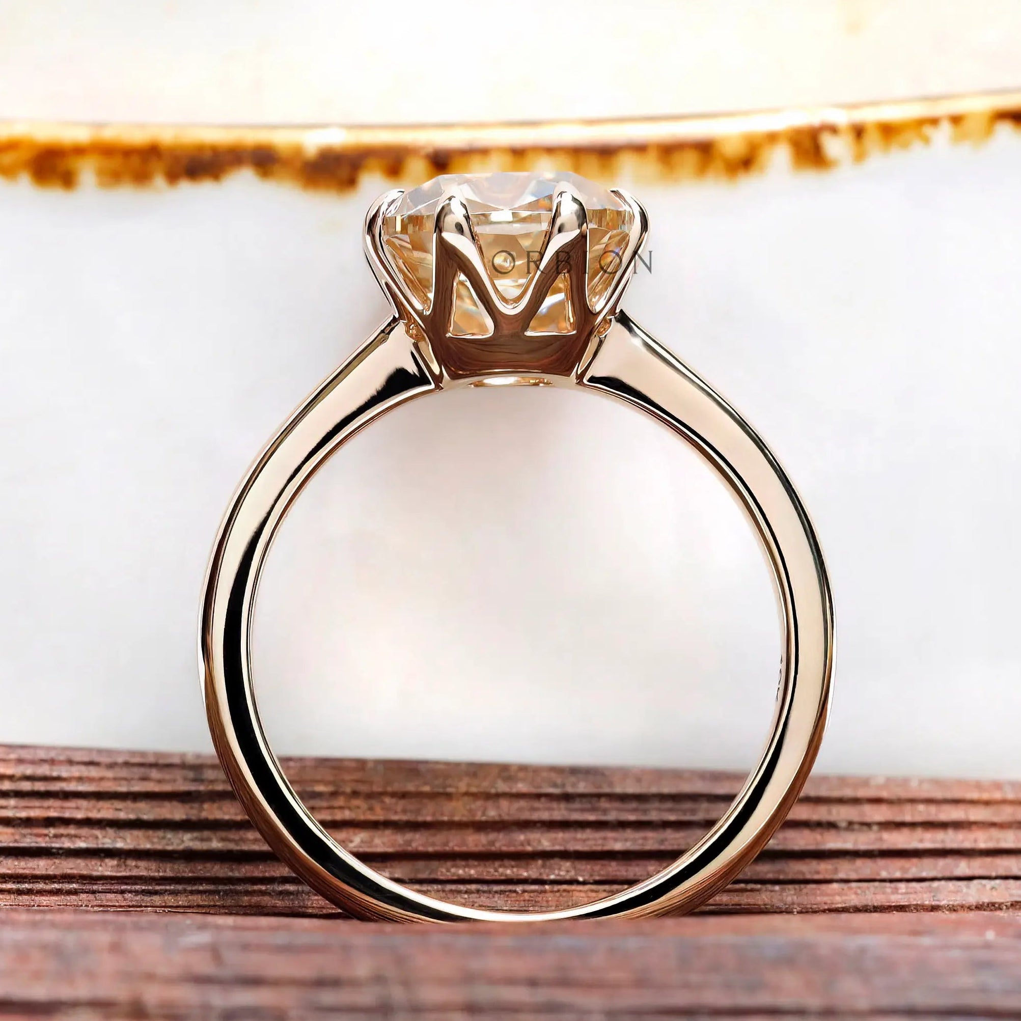 Rear view of cushion moissanite solitaire ring with polished yellow gold band