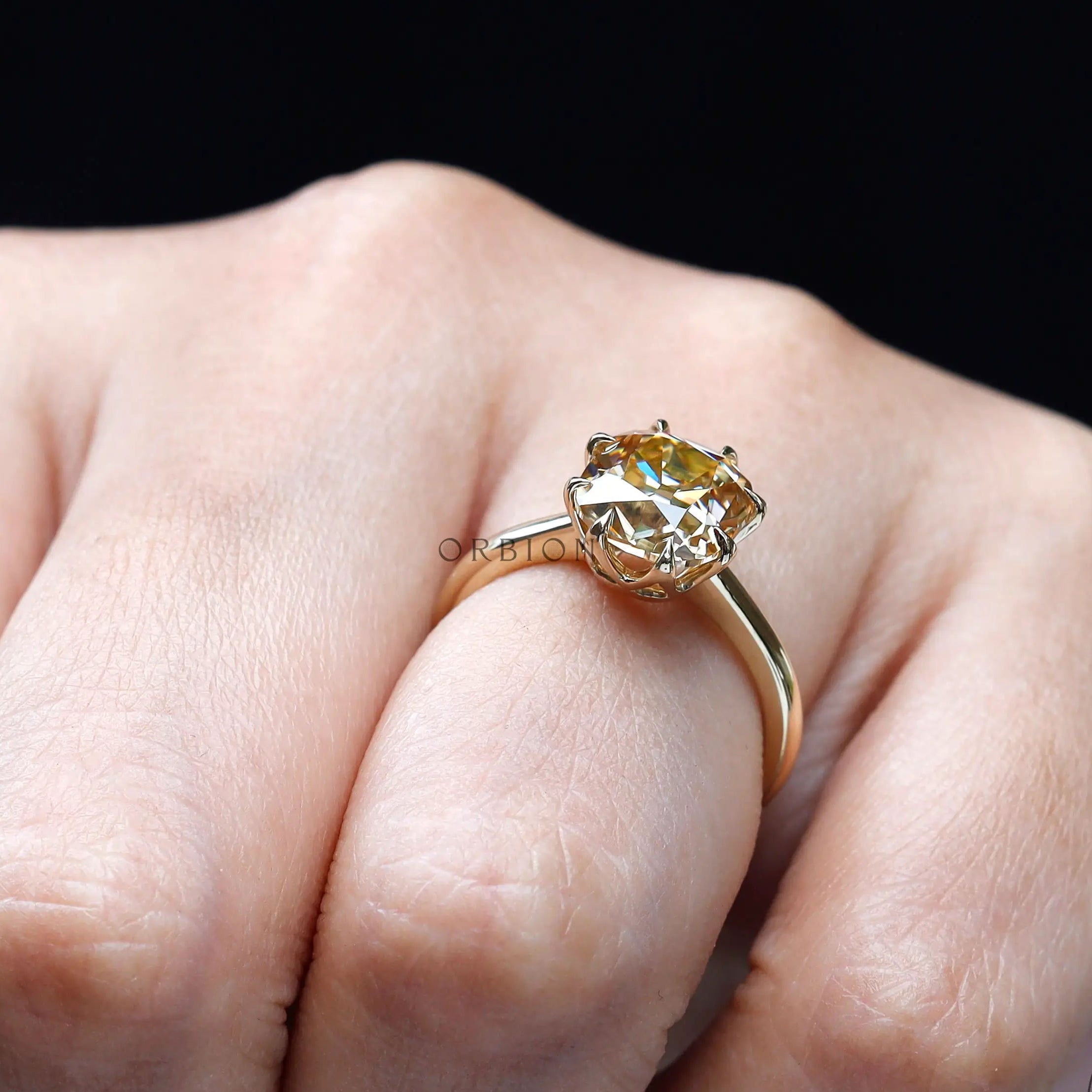 Hand-held side angle of cushion Old Mine Cut moissanite solitaire ring