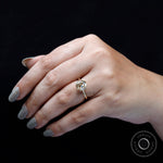 Cushion Old Mine Cut light champagne moissanite ring worn on finger close-up