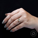 Cushion Old Mine Cut light champagne moissanite ring worn on finger close-up
