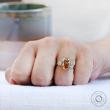 Pear shaped champagne moissanite three stone ring on fingure