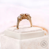Antique style pear champagne moissanite ring with round accents side view