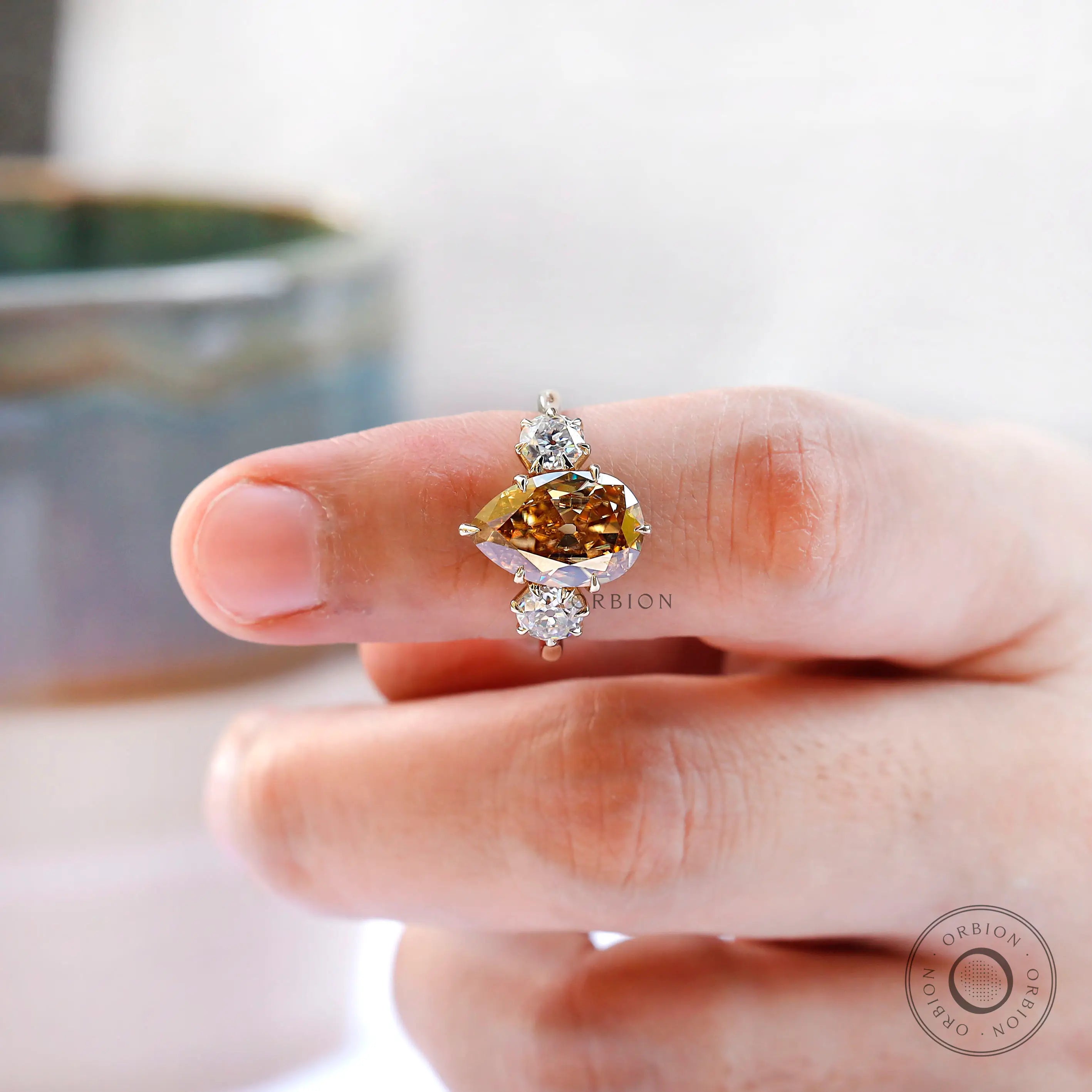 Elegant large pear shaped champagne moissanite trilogy ring