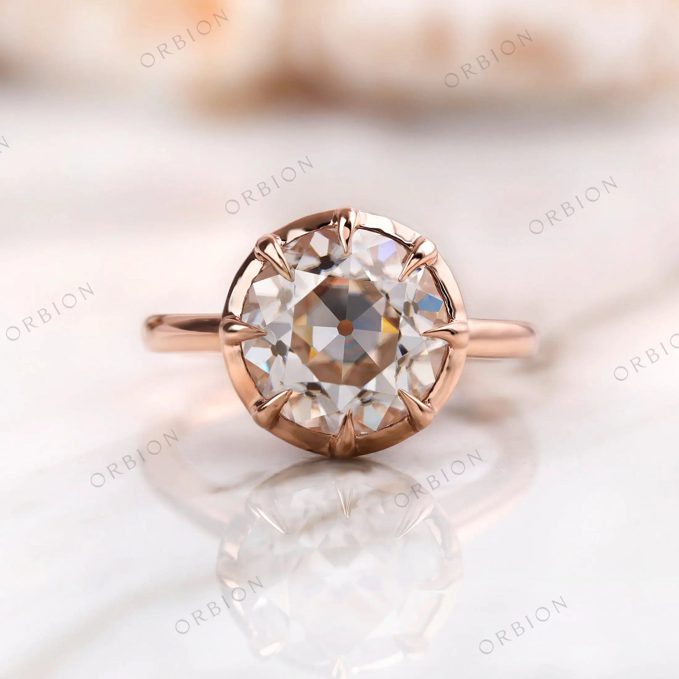 Front view of round Old European cut moissanite solitaire ring in rose gold