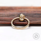 Underside view of pear moissanite solitaire ring