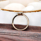 Top angled view highlighting pear moissanite stone
