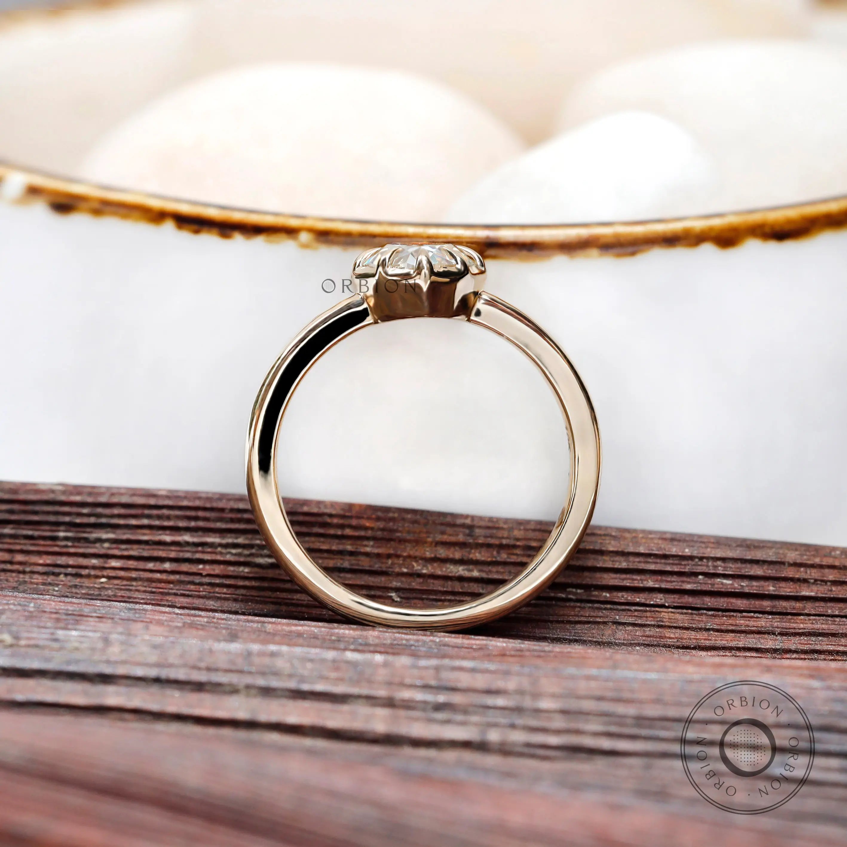 Top angled view highlighting pear moissanite stone