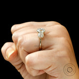 Hand worn three stone cushion moissanite ring side view