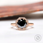 Front view of black moissanite halo ring with white moissanite accents