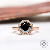 Front view of black moissanite halo ring with white moissanite accents