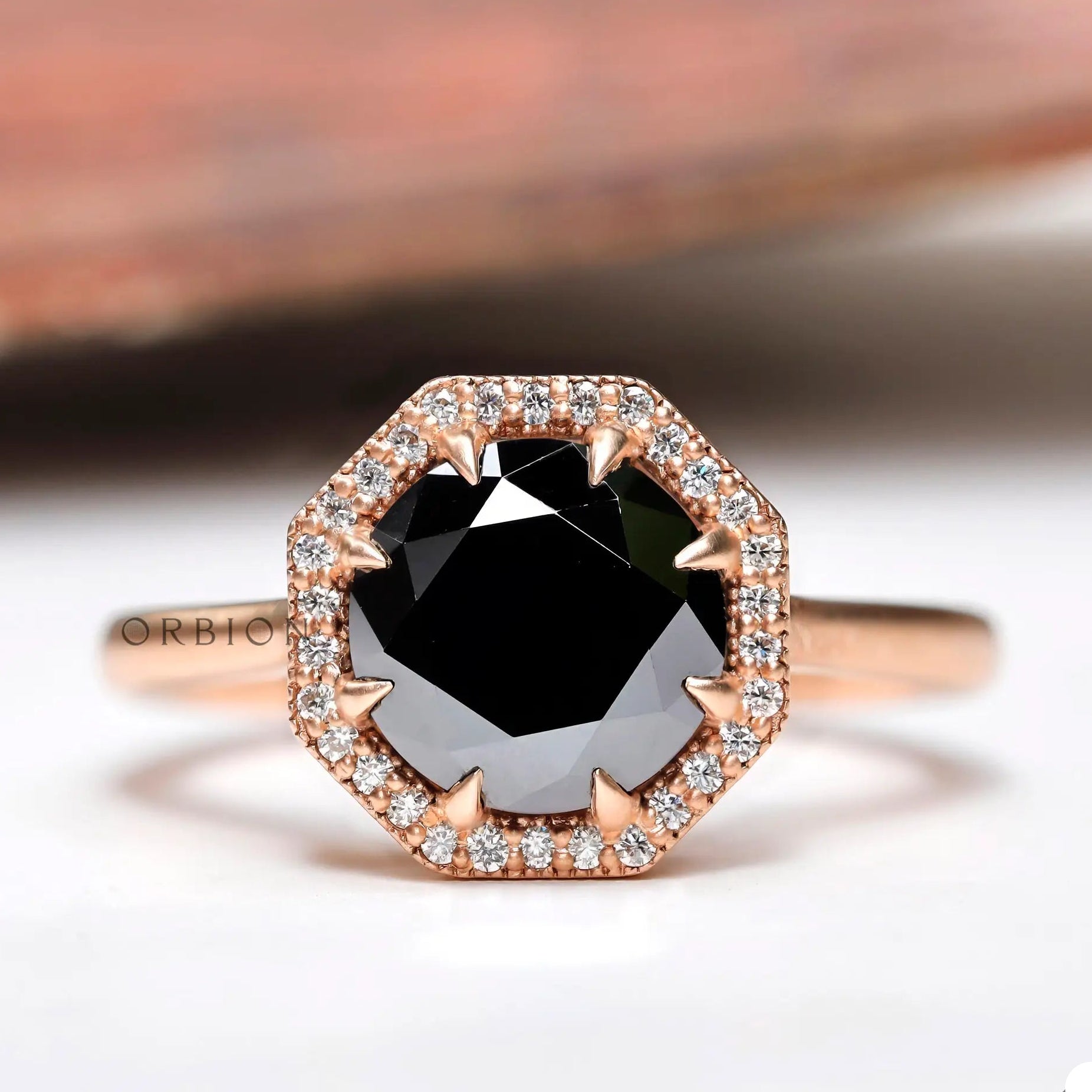 Front view of black moissanite halo ring with white moissanite accents