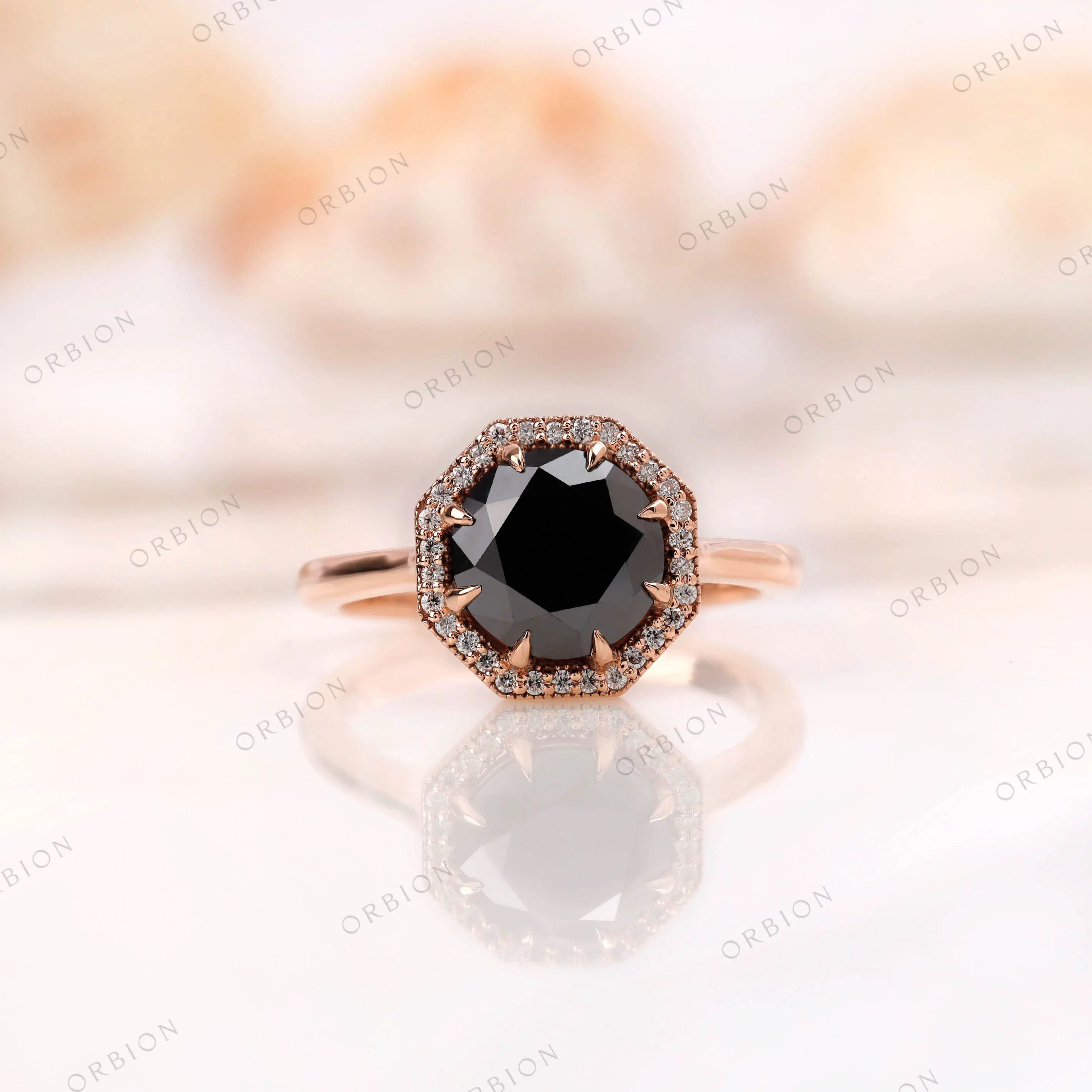 Octagon black moissanite engagement ring with halo in 10K rose gold.