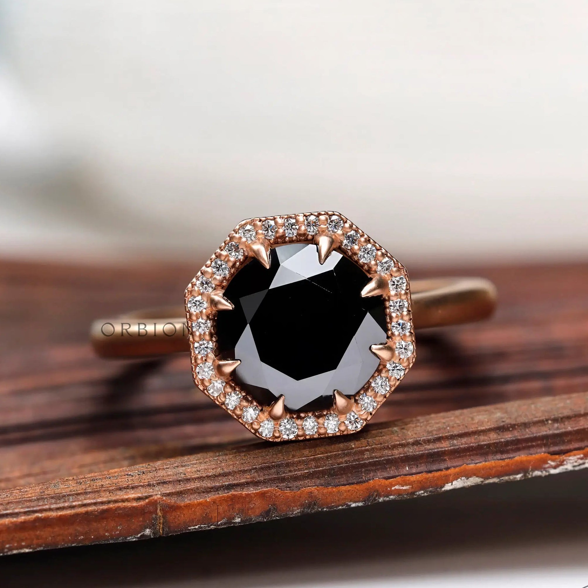 Angled close-up of black moissanite center stone with halo setting