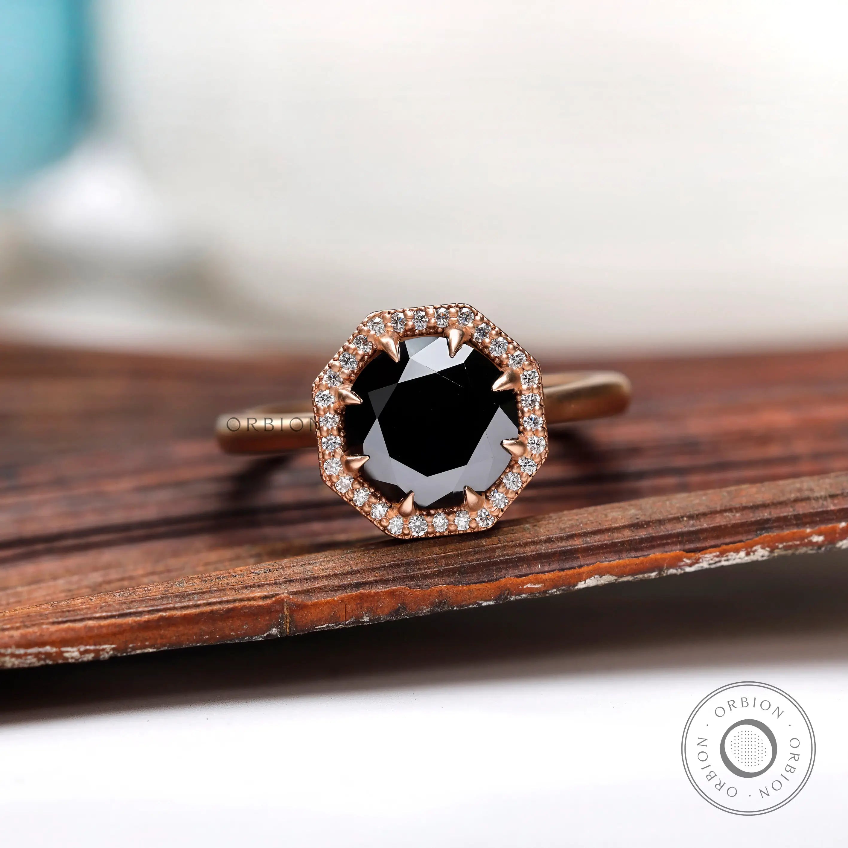 Angled close-up of black moissanite center stone with halo setting