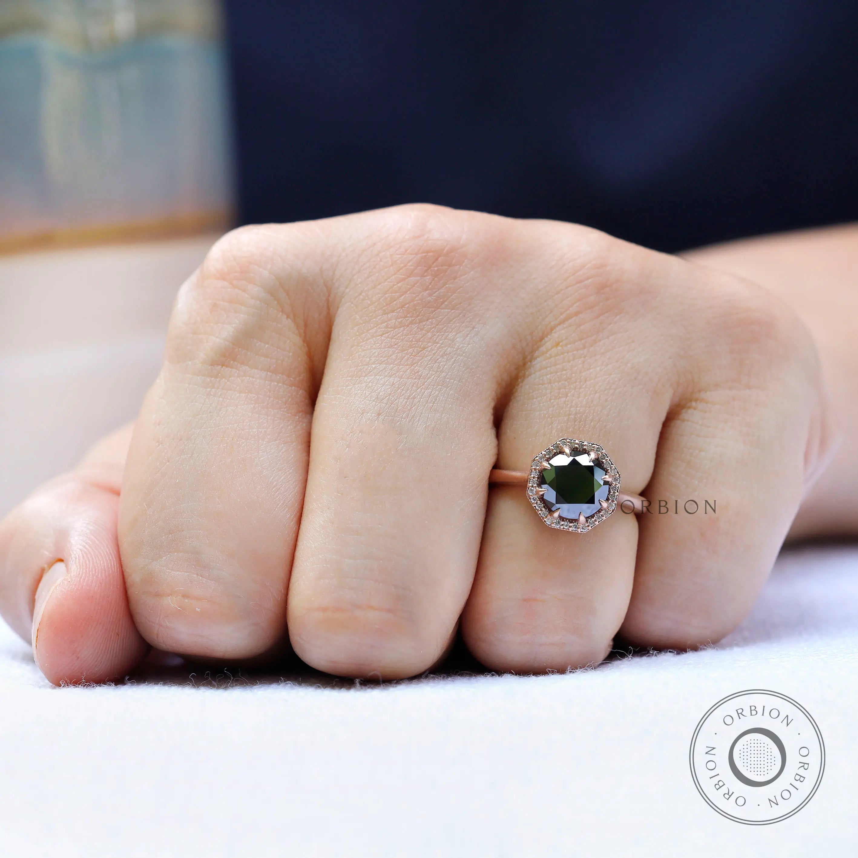 Lifestyle on-hand view of black moissanite halo engagement ring
