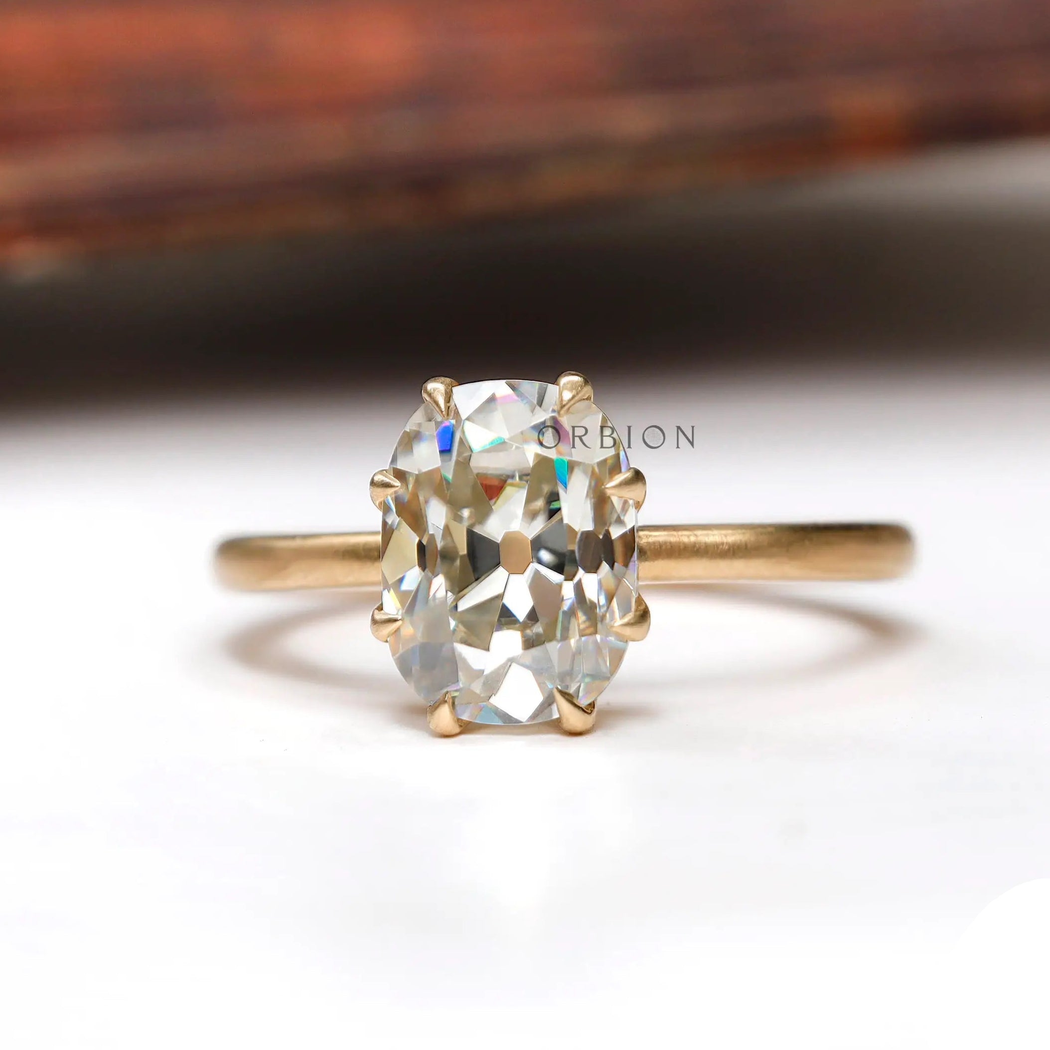 Elongated cushion Old Mine Cut moissanite solitaire ring in yellow gold front view