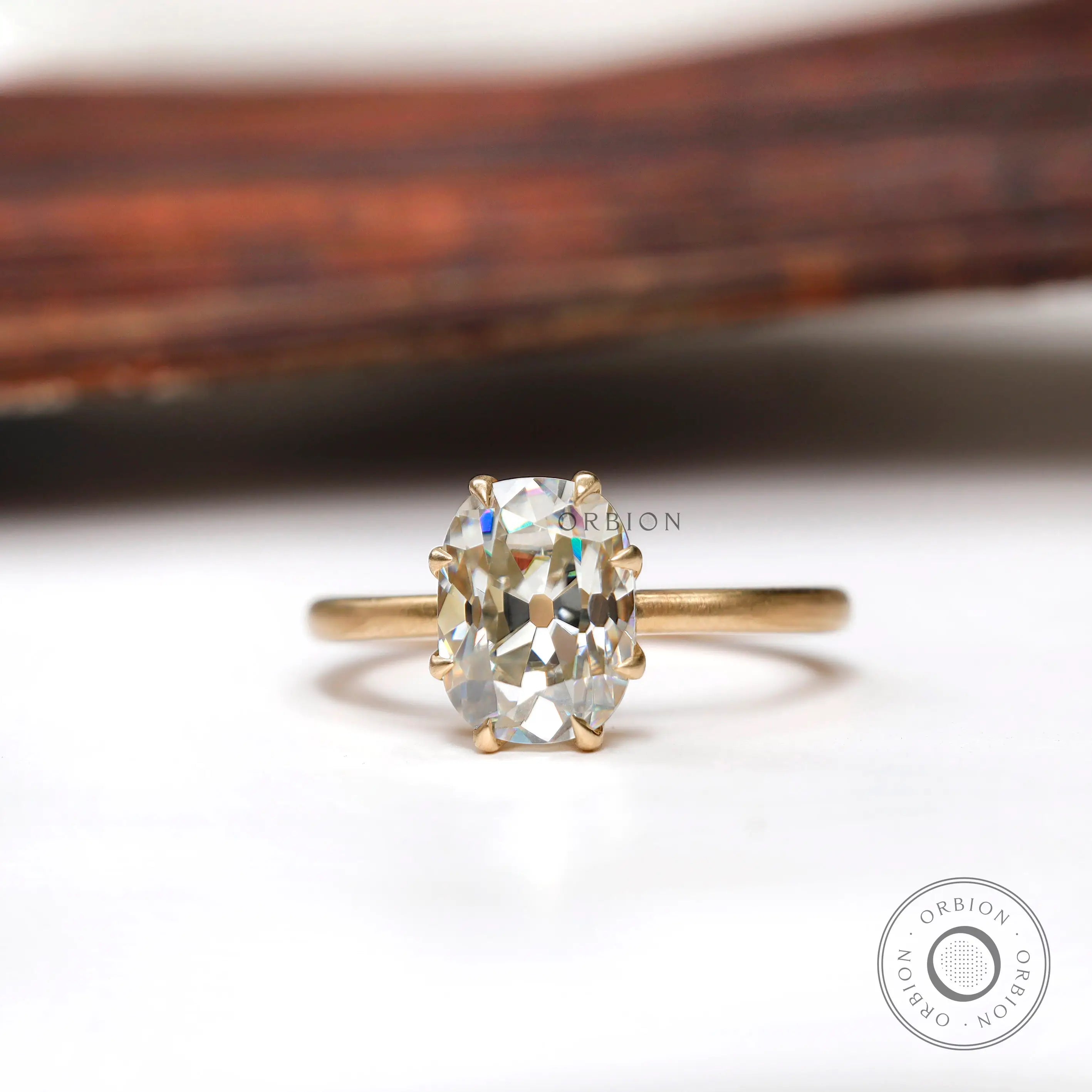 Elongated cushion Old Mine Cut moissanite solitaire ring in yellow gold front view