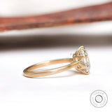 Side profile of elongated cushion moissanite solitaire ring in 10K yellow gold