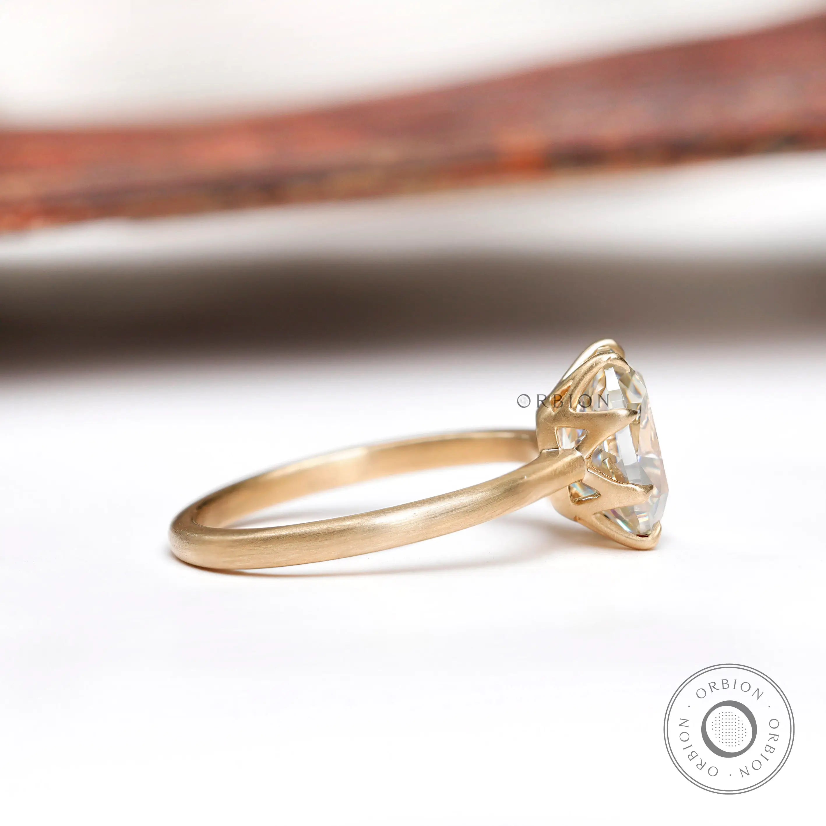 Side profile of elongated cushion moissanite solitaire ring in 10K yellow gold