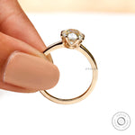Elongated cushion moissanite solitaire ring on white background