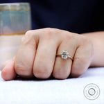 Lifestyle hand shot of yellow gold moissanite solitaire ring