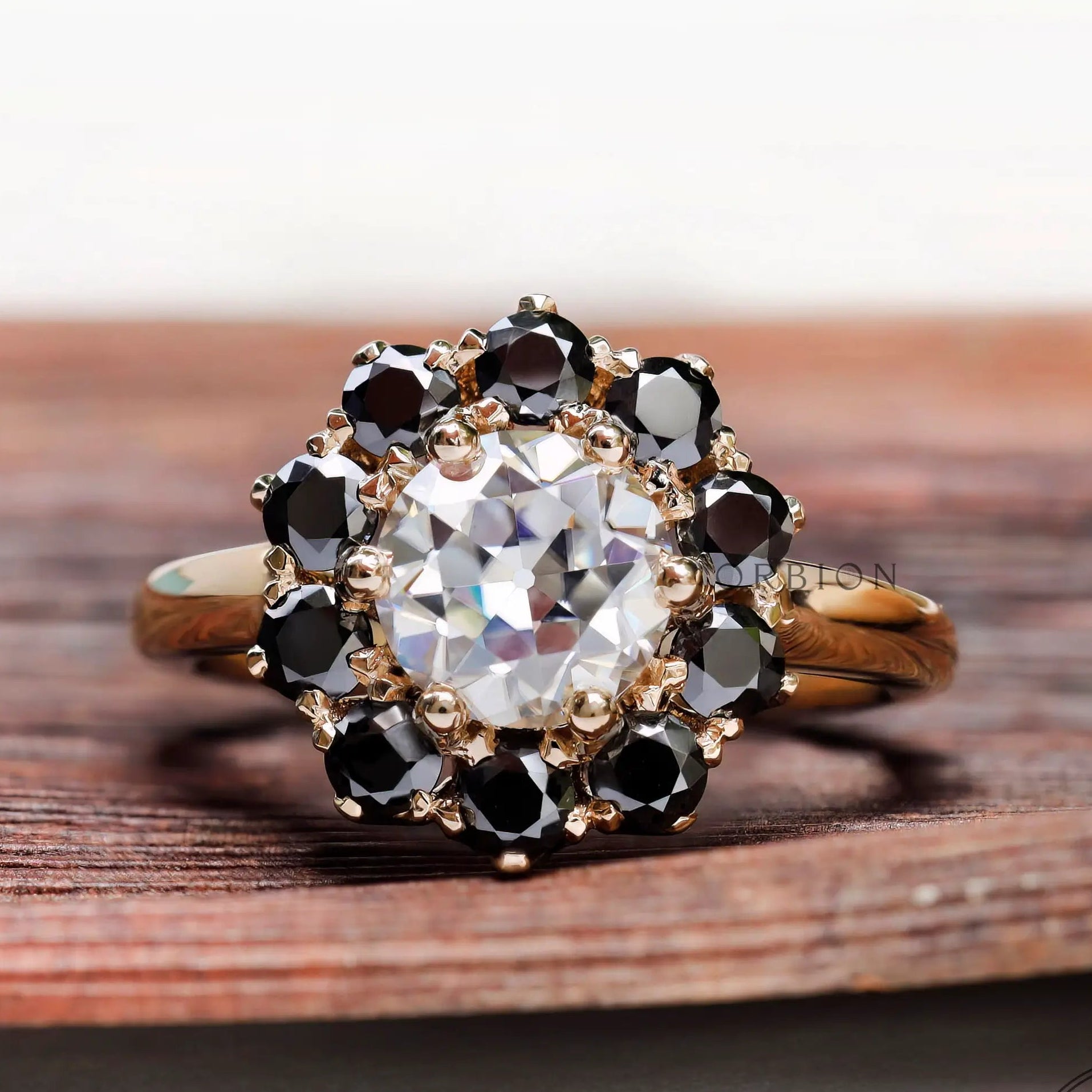 Vintage halo moissanite ring with black accent stones top view