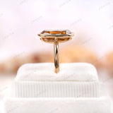 Detailed rear side view of champagne moissanite bezel ring on box