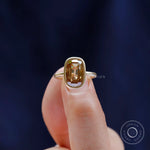 Contemporary bezel set champagne moissanite solitaire ring close up