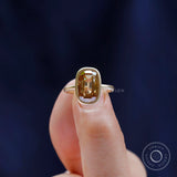 Contemporary bezel set champagne moissanite solitaire ring close up