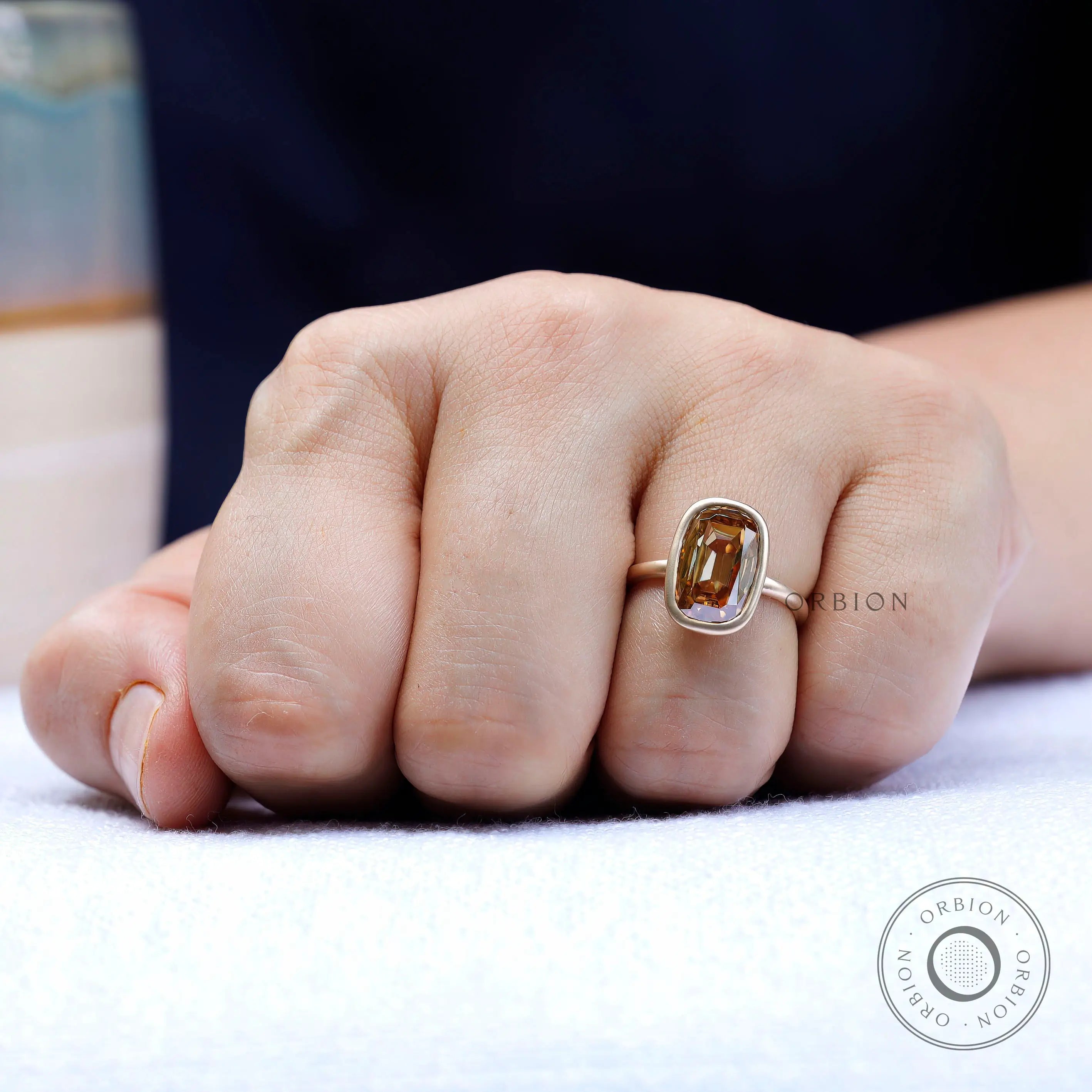 Close up of elongated cushion moissanite bezel setting