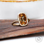 Matt finish yellow gold bezel moissanite ring side view