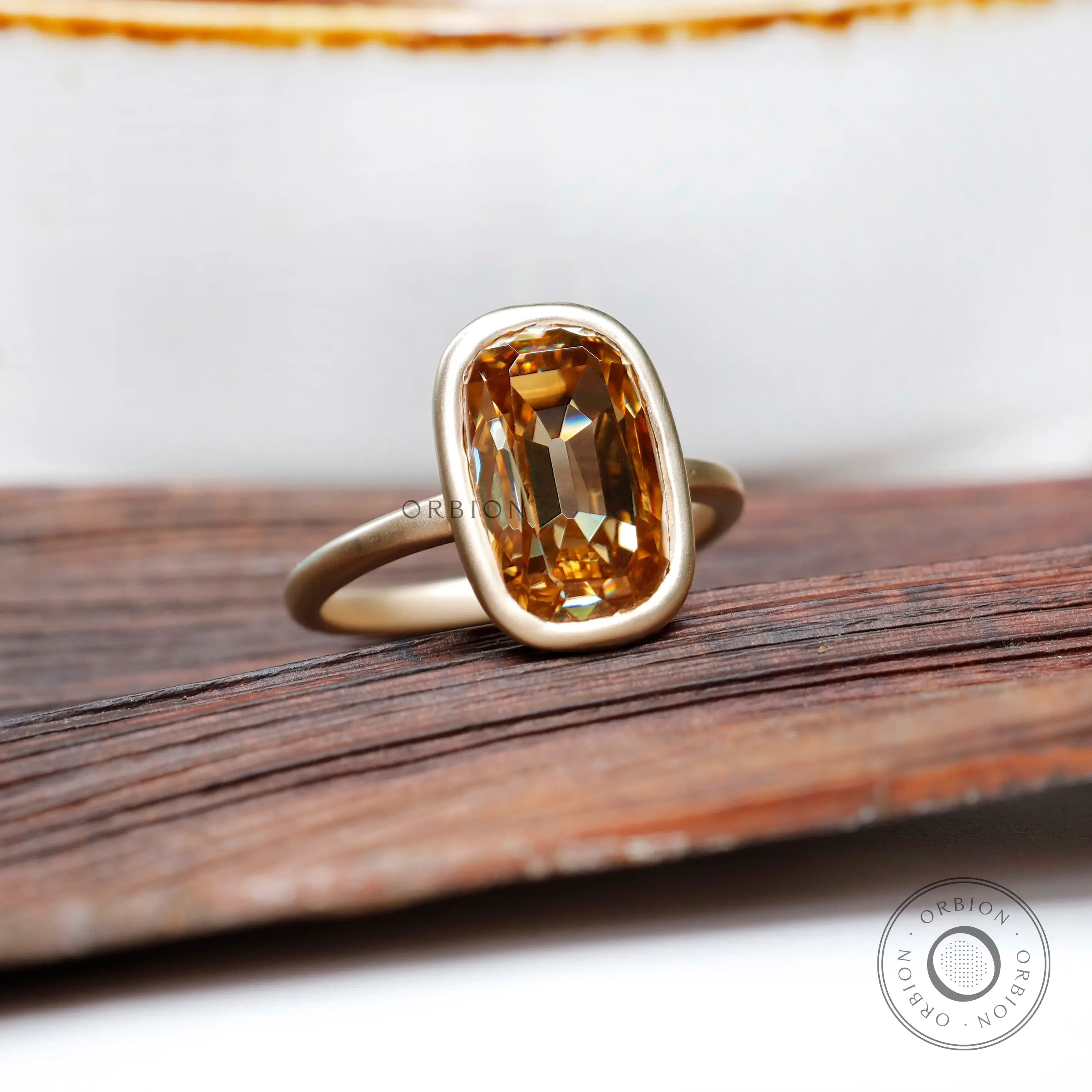 Matt finish yellow gold bezel moissanite ring side view