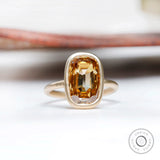 Elongated cushion champagne moissanite bezel set ring in 14K yellow gold