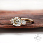 Profile view of three stone moissanite ring showing prong setting