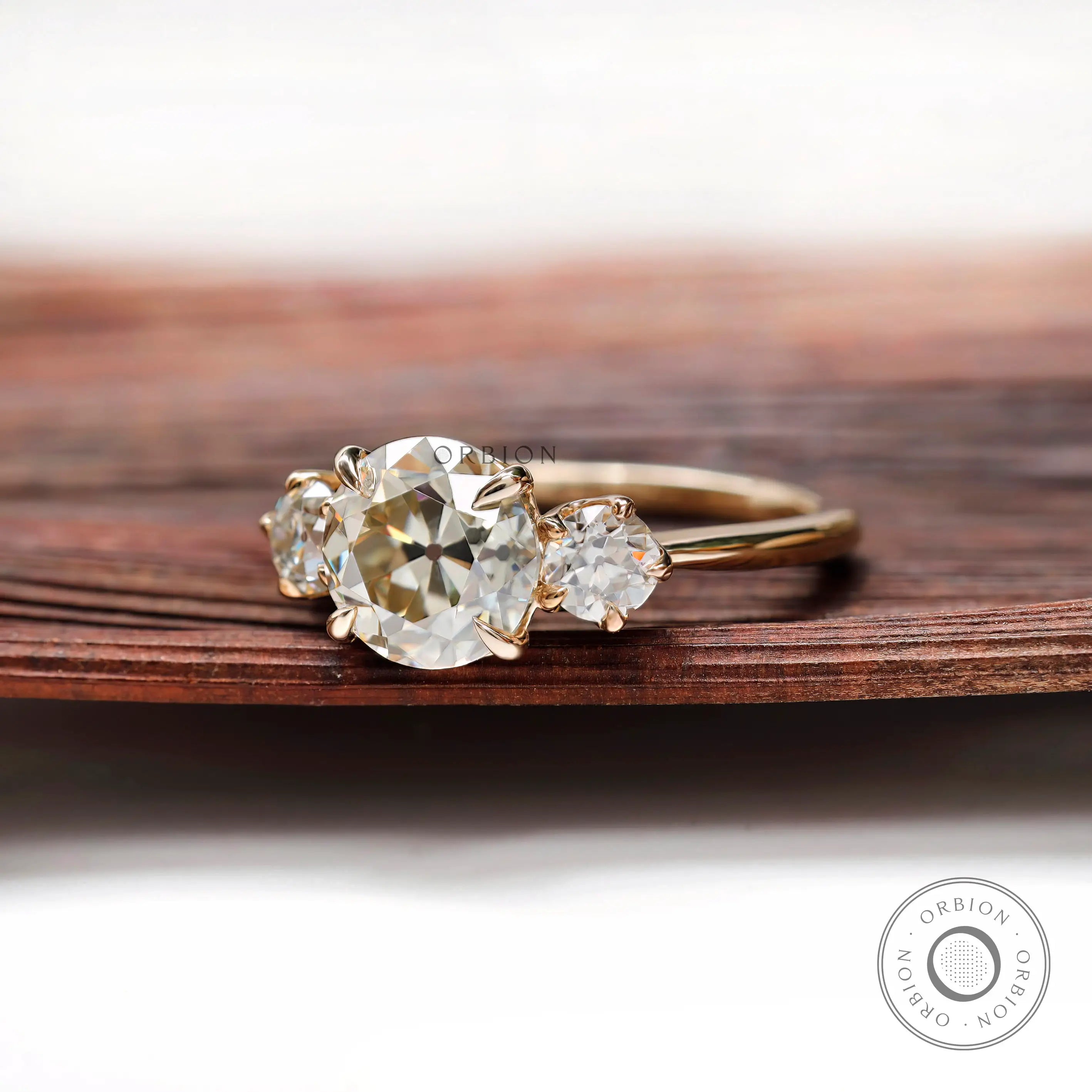 Profile view of three stone moissanite ring showing prong setting