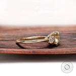 Side angle view of three stone moissanite ring with round stones