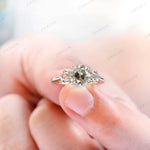 Close detail of round moissanite side stones in prong setting
