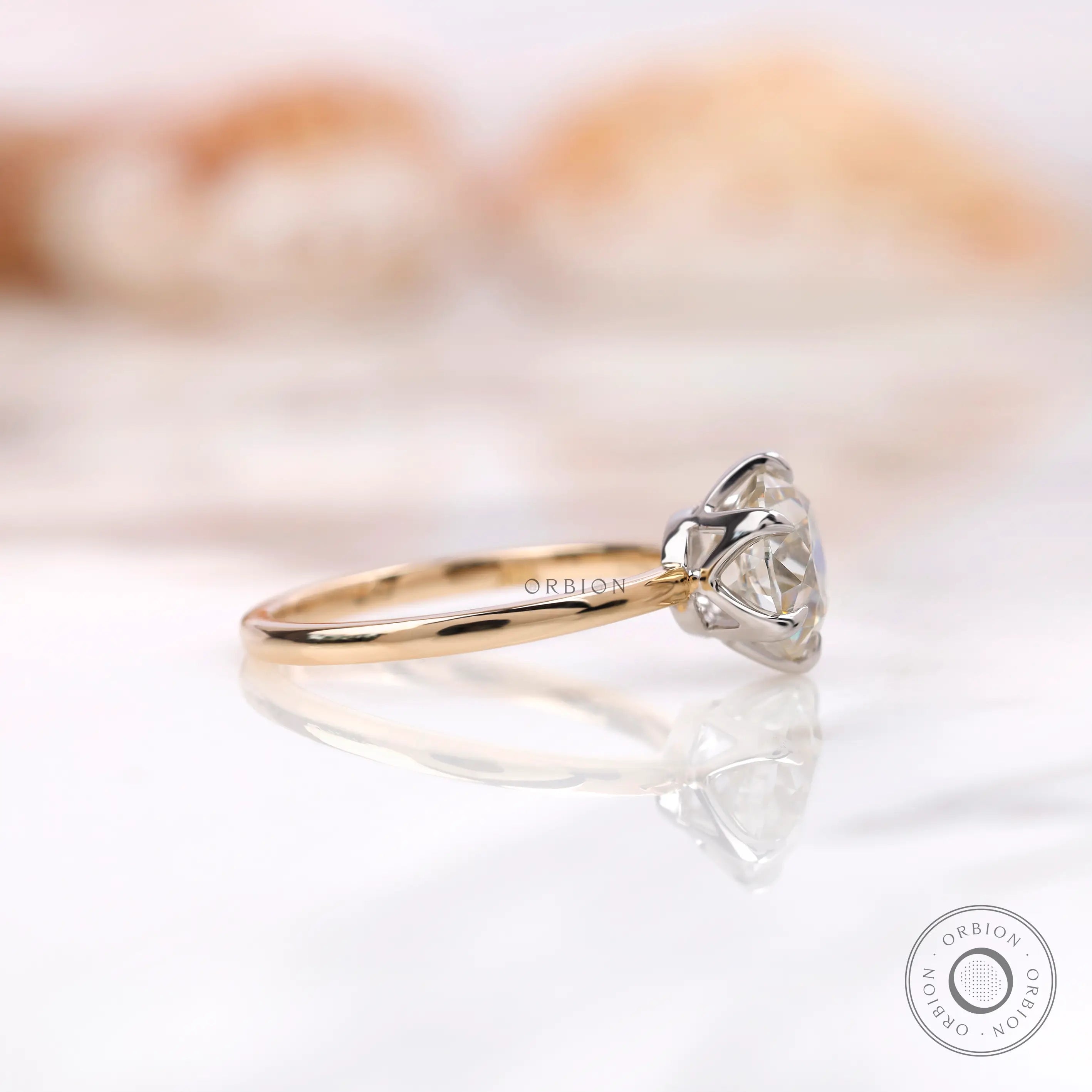 Side profile view of six prong solitaire OEC Moissanite engagement ring.