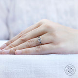 Minimal three stone moissanite ring on hand