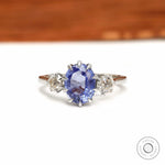 Oval lab grown sapphire engagement ring with vintage diamond accents
