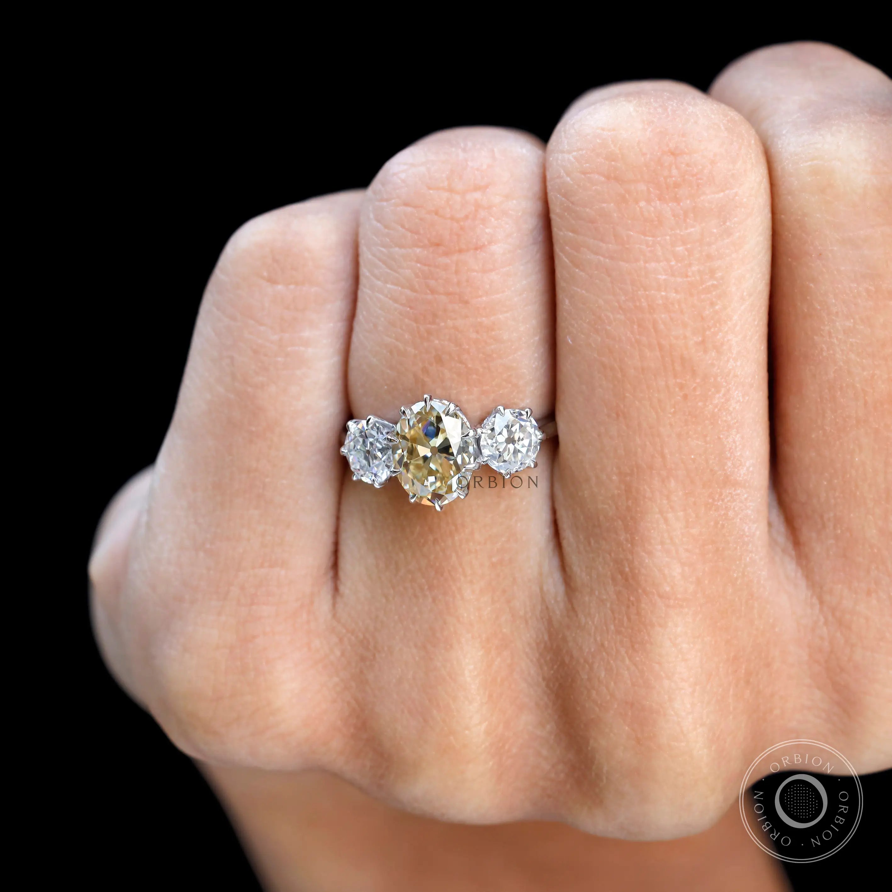 Champagne moissanite oval 3 stone ring close up view